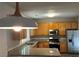 Kitchen with granite countertops, stainless steel appliances, and light wood cabinets, blending style with functionality at 1415 Stoney Field Pl, Lawrenceville, GA 30043