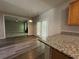 Kitchen with granite countertop and a view to the living room through a pair of French doors at 1415 Stoney Field Pl, Lawrenceville, GA 30043