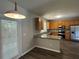 Well-lit kitchen featuring granite countertops, stainless steel appliances, and door to the backyard at 1415 Stoney Field Pl, Lawrenceville, GA 30043