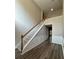Inviting stairway featuring wood flooring, white railings, and carpeted steps at 1415 Stoney Field Pl, Lawrenceville, GA 30043