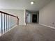 Upstairs landing with neutral carpet and wood railing overlooks the foyer below, offering ample space and natural light at 1415 Stoney Field Pl, Lawrenceville, GA 30043