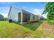 Green backyard with well-manicured lawn, side view of house with covered porch at 175 Orchard Ln, Covington, GA 30014