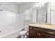 Bathroom featuring a shower-tub, granite vanity, and light fixtures at 175 Orchard Ln, Covington, GA 30014