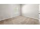 Cozy bedroom with neutral walls, carpet, and a window at 175 Orchard Ln, Covington, GA 30014