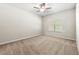 Bright, carpeted bedroom with a ceiling fan and natural light from a window at 175 Orchard Ln, Covington, GA 30014