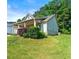 Exterior side view showing the home's design, landscaping, and well-maintained yard at 175 Orchard Ln, Covington, GA 30014
