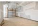 Spacious, unfinished garage with a concrete floor and white walls at 175 Orchard Ln, Covington, GA 30014