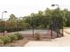 Community tennis court with secure fencing, lighting, and a well-maintained playing surface at 175 Orchard Ln, Covington, GA 30014