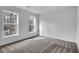 This bedroom is bright and open, featuring two windows and neutral-colored carpet at 3290 Ethan Drive, Marietta, GA 30062
