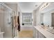 Bathroom features a glass shower, soaking tub under window and neutral colored flooring at 451 Tioram Se Ln, Smyrna, GA 30082