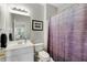 Bathroom showcasing a single sink vanity, toilet, shower, and black and white cityscape art at 451 Tioram Se Ln, Smyrna, GA 30082