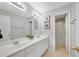 Bright bathroom featuring a double sink vanity, a large mirror, and a separate shower at 451 Tioram Se Ln, Smyrna, GA 30082