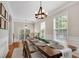 Open dining room with hardwood floors, large windows, and a decorative chandelier at 451 Tioram Se Ln, Smyrna, GA 30082