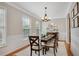 Bright dining room with wainscoting, hardwood floors and an elegant chandelier at 451 Tioram Se Ln, Smyrna, GA 30082