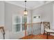 Upstairs hallway featuring wood floors, natural light and decorative wrought iron railing at 451 Tioram Se Ln, Smyrna, GA 30082