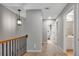 Well-lit hallway with wrought iron railing leading to multiple rooms at 451 Tioram Se Ln, Smyrna, GA 30082
