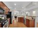 Open kitchen with stainless steel appliances, hardwood floors, and bar seating area at 451 Tioram Se Ln, Smyrna, GA 30082