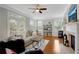 This living room has tons of natural light, a fireplace, and hardwood floors at 451 Tioram Se Ln, Smyrna, GA 30082