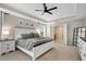 Bright main bedroom features a tray ceiling, ceiling fan, and a neutral color palette at 451 Tioram Se Ln, Smyrna, GA 30082