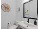 Modern half bath with sleek fixtures, vanity, and neutral decor at 518 Hargrove Ln, Decatur, GA 30030