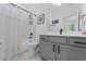 Well-lit bathroom with a shower, modern vanity, and neutral color scheme at 518 Hargrove Ln, Decatur, GA 30030