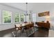 Sunny dining room with hardwood floors, designer lighting, and large windows at 518 Hargrove Ln, Decatur, GA 30030