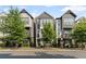 Charming townhome with modern facade, black metal fences, and well-maintained landscaping along the street at 518 Hargrove Ln, Decatur, GA 30030