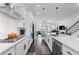 Modern kitchen featuring stainless steel appliances, white cabinets, and a view to the living area at 518 Hargrove Ln, Decatur, GA 30030
