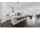 Modern kitchen with white cabinets, a large island with barstool seating, and stainless steel appliances at 518 Hargrove Ln, Decatur, GA 30030