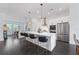 Open concept kitchen with a large island, modern pendant lighting, and stainless steel appliances at 518 Hargrove Ln, Decatur, GA 30030