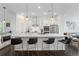 Open kitchen with island bar, stainless appliances, modern lighting, and living room access at 518 Hargrove Ln, Decatur, GA 30030