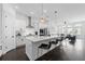 Open concept kitchen with white cabinets, stainless appliances, island seating, and natural light at 518 Hargrove Ln, Decatur, GA 30030