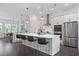 Bright kitchen with a large center island, stainless appliances, and modern pendant lighting at 518 Hargrove Ln, Decatur, GA 30030