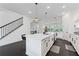 Modern kitchen with a large island, black bar stools, white cabinets, and stainless steel appliances at 518 Hargrove Ln, Decatur, GA 30030