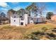 A rear exterior view of a white home with a chimney, deck, and outdoor access at 1536 Daffodil Drive, Marietta, GA 30062