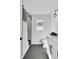 Well-lit bathroom with a tiled shower, gray floors, and a modern vanity at 1536 Daffodil Drive, Marietta, GA 30062