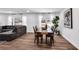Dining room with hardwood floors, a wooden table, and a view into the living room at 1536 Daffodil Drive, Marietta, GA 30062
