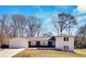 Charming renovated home with a two-car garage, black and white facade, and a lush green front lawn at 1536 Daffodil Drive, Marietta, GA 30062