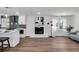 Bright living room with a brick fireplace, hardwood floors, and kitchen access at 1536 Daffodil Drive, Marietta, GA 30062