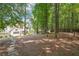 Secluded backyard with mature trees providing shade and privacy, stone path at 9811 Spyglass Dr, Villa Rica, GA 30180