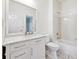 Bright bathroom featuring a white vanity with granite countertop and soaking tub at 9811 Spyglass Dr, Villa Rica, GA 30180