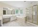 Spacious bathroom featuring double sinks, large mirrors, a tub, and glass enclosed shower at 9811 Spyglass Dr, Villa Rica, GA 30180
