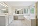 Bright bathroom featuring dual sinks, large mirrors, and a separate tub at 9811 Spyglass Dr, Villa Rica, GA 30180