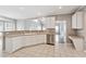 Open kitchen featuring white cabinets, a breakfast bar, and views into adjacent living spaces, perfect for entertaining at 9811 Spyglass Dr, Villa Rica, GA 30180