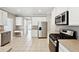 Well-lit kitchen features modern stainless steel appliances, white cabinetry, and ample counter space for cooking at 9811 Spyglass Dr, Villa Rica, GA 30180