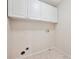 Utility room featuring overhead storage cabinets, tile floor and washer/dryer hookups at 9811 Spyglass Dr, Villa Rica, GA 30180