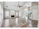 Inviting living room with soaring ceilings, a cozy fireplace, and beautiful hardwood floors leading to the staircase at 9811 Spyglass Dr, Villa Rica, GA 30180