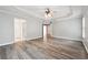 Spacious main bedroom with tray ceilings, ceiling fan, and light grey walls at 9811 Spyglass Dr, Villa Rica, GA 30180