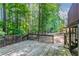 Inviting backyard deck with wooden railing surrounded by lush trees and greenery at 12015 Harbour Town Pkwy, Fayetteville, GA 30215