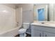 Bright bathroom with a tub-shower combination and a white vanity at 12015 Harbour Town Pkwy, Fayetteville, GA 30215